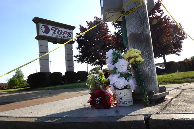 Flowers are left at a makeshift memorial outside of Tops market on May 15th in Buffalo.